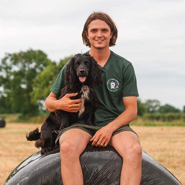 Dog with owner at entrance to Tail Trail dog walk in Rossett, Wrexham