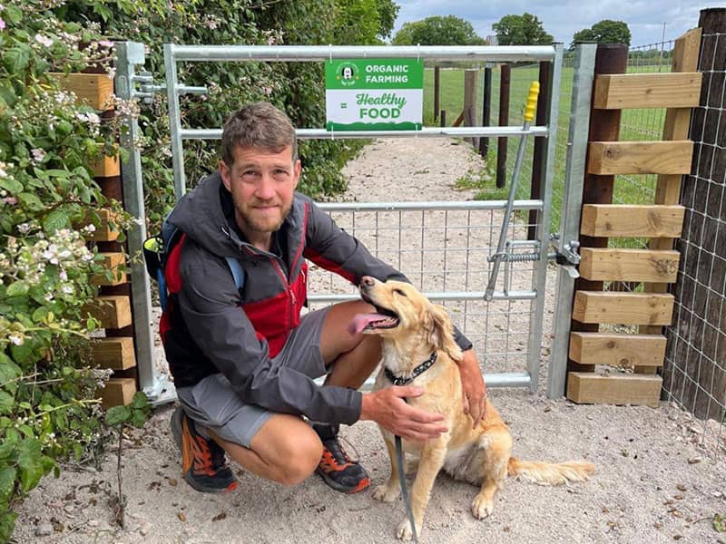 Owner with his dog at entrance to the Tail Trail