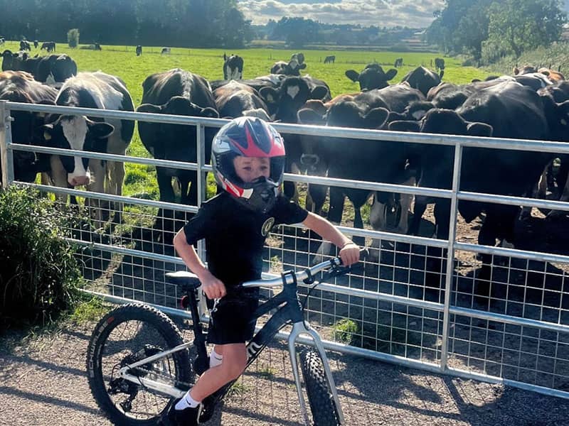 Child on bike next to farmland in Wrexham